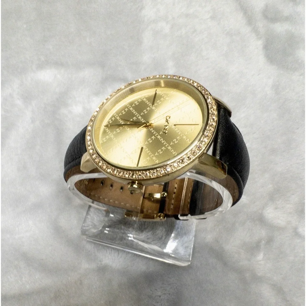 DKNY 111007 Gold Tone All Over Logo Womens 43mm Wristwatch Gem Set Bezel